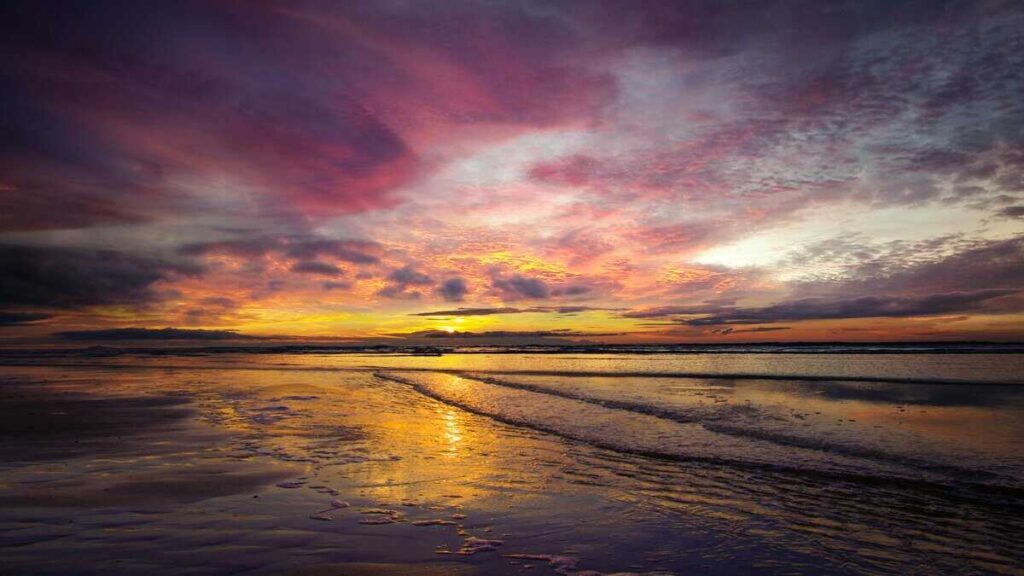 Golden sunset reflecting on ocean waves at beach shore, symbolizing hope and divine timing in Christian poetry