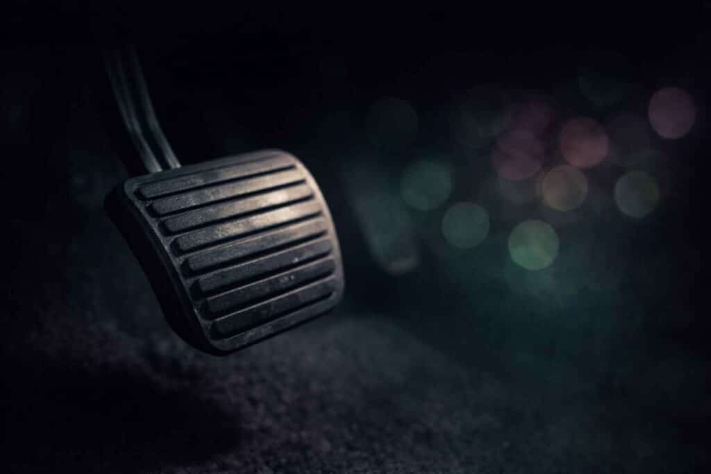 Car brake pedal representing the concept of pumping the brakes on emotional reactions at work